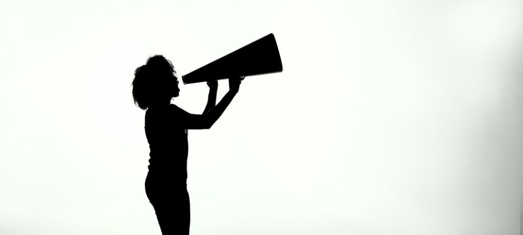 Silhouette of a person using a megaphone, symbolising amplifying a message.